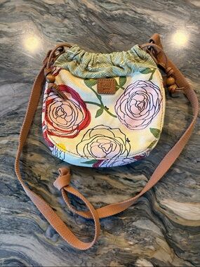 Fossil canvas cross body with elastic top give and magnetic snap closure .  NWOT